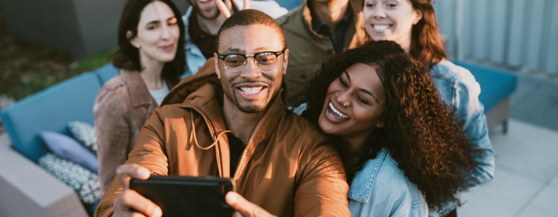 friends take a group selfie outdoors