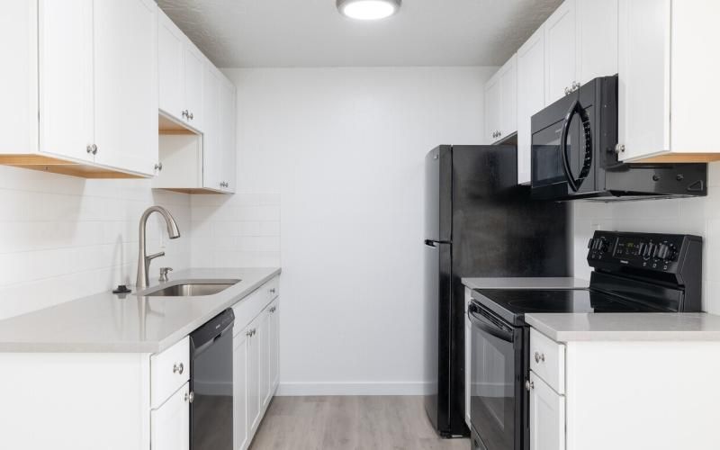 a kitchen with white cabinets